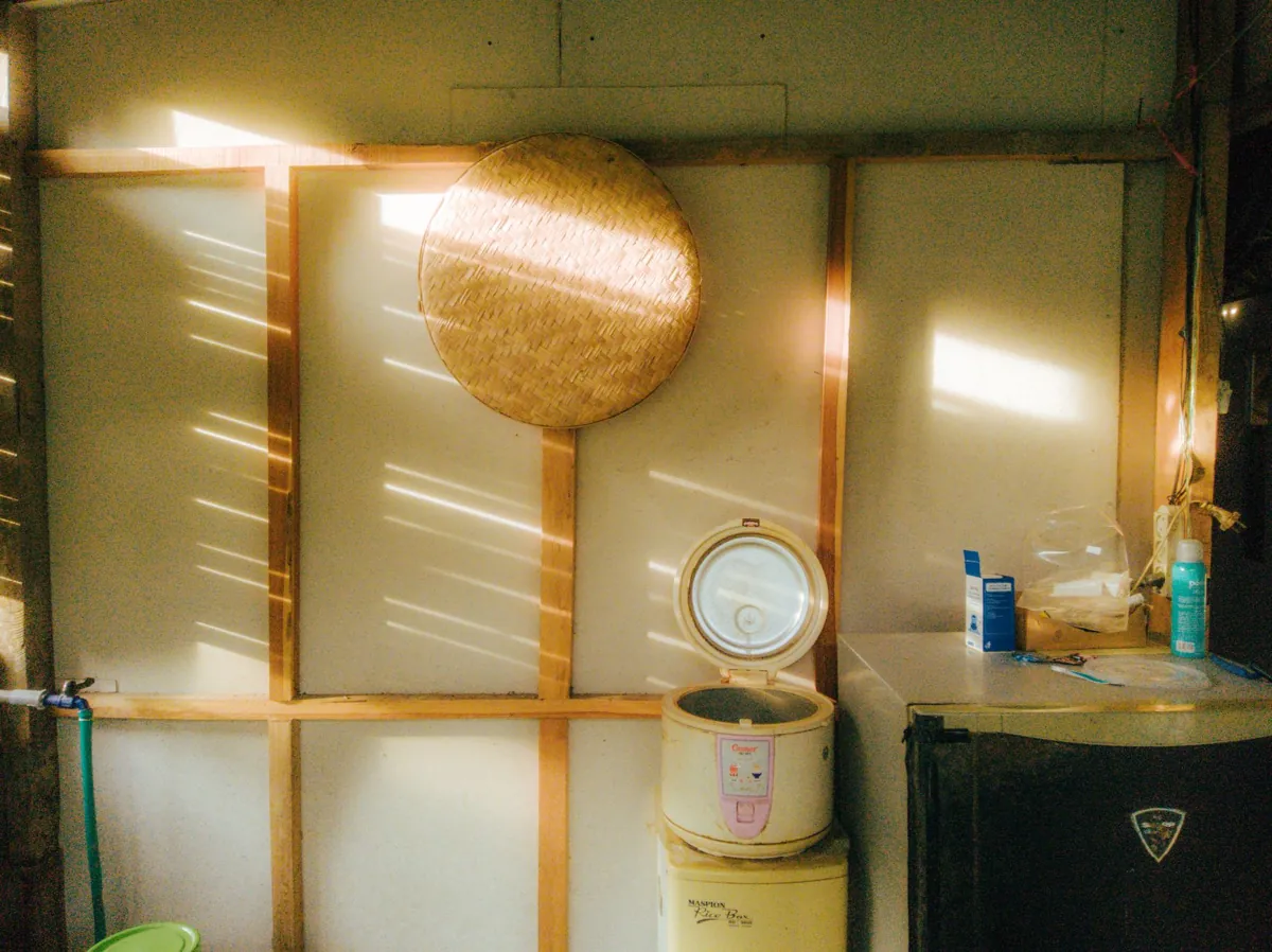 Vintage style kitchen with a rice cooker and sunlight streaming through, creating a nostalgic ambiance.